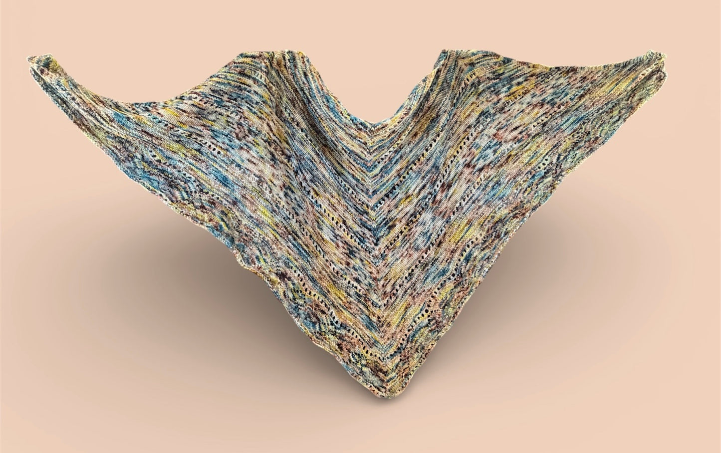 Multicolored knitted shawl on a beige background